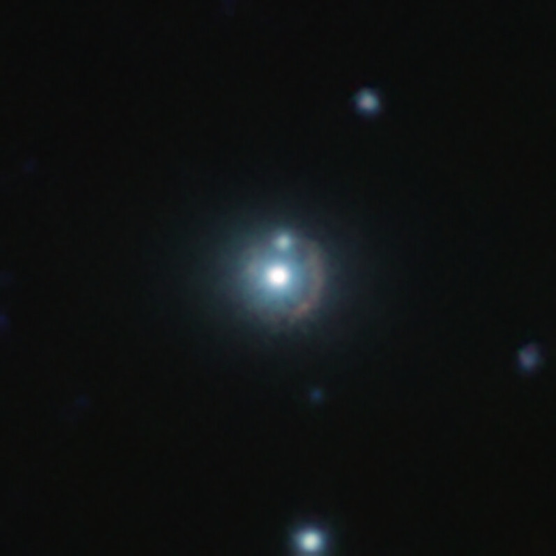 A fuzzy circle with 2 bright spots and other bright spots around it, on a black background.